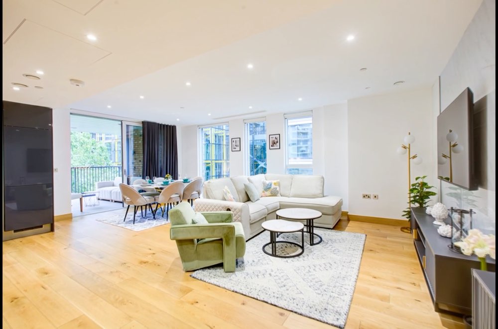An open-plan living room with the dining table beyond.